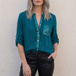 Dark green women's summer blouse with V-neck and button-front denim design, by FJØRNA, styled as a casual top.