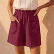 Dark red women's summer shorts by FJØRNA with linen fabric and practical pockets, casual and comfortable for warm weather.