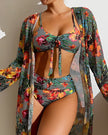 Women's floral bikini set with ruffles, three-piece swimwear from FJØRNA featuring a colorful flower print and ruffled details.