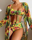 Women's floral bikini set with ruffle details, three-piece swimwear by FJØRNA, featuring a top, bottom, and cover-up.