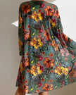 Women's three-piece floral bikini set with ruffles from FJØRNA, featuring a top, bottom, and cover-up with colorful floral print.
