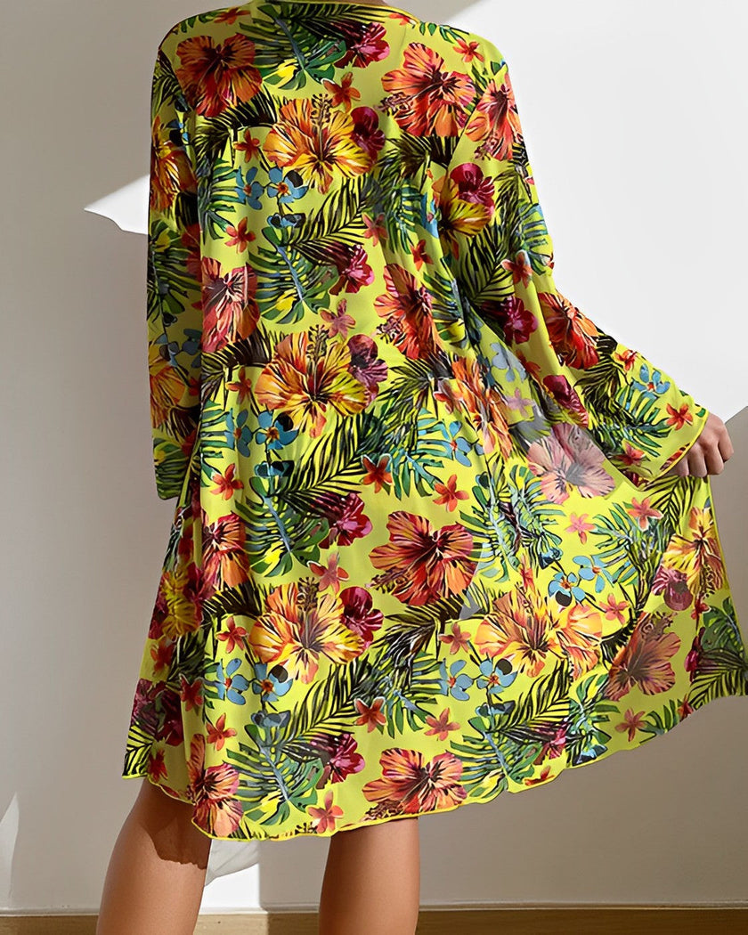 Women's floral bikini set with ruffles, three-piece swimwear by FJØRNA featuring colorful flower print and ruffled details.
