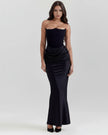 Velvet women's strapless corset maxi dress with ruched detail from FJØRNA, showcasing a fitted bodice and flowing skirt.