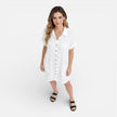 Light beige women's linen shirt dress by FJØRNA with button front and side pockets, perfect for casual summer wear.
