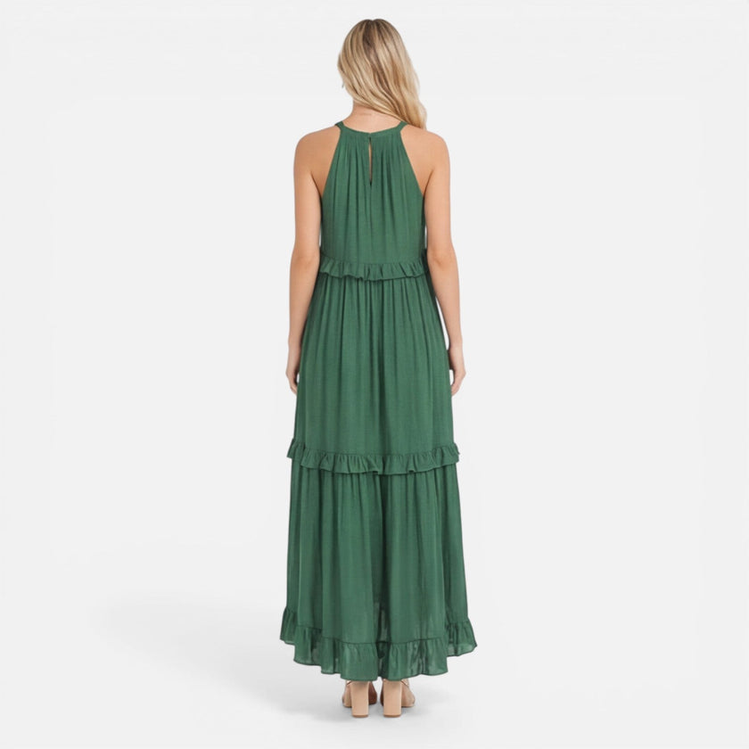 Lightweight, flowy women's tiered maxi dress with halter neck by FJØRNA, perfect for summer, shown on a model.