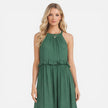 Lightweight women's tiered maxi dress by FJØRNA with a flowy silhouette and halter neck, perfect for summer wear.