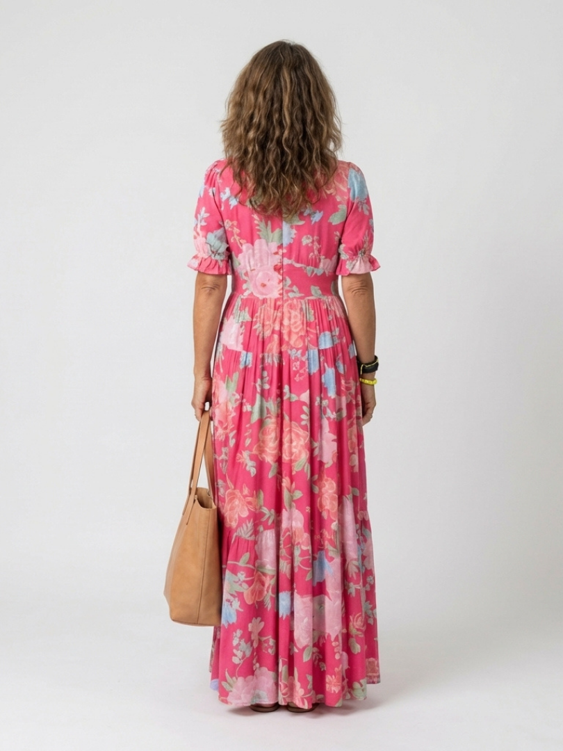 FJØRNA summer midi dress for women with floral pattern and short sleeves, perfect for warm-weather occasions.