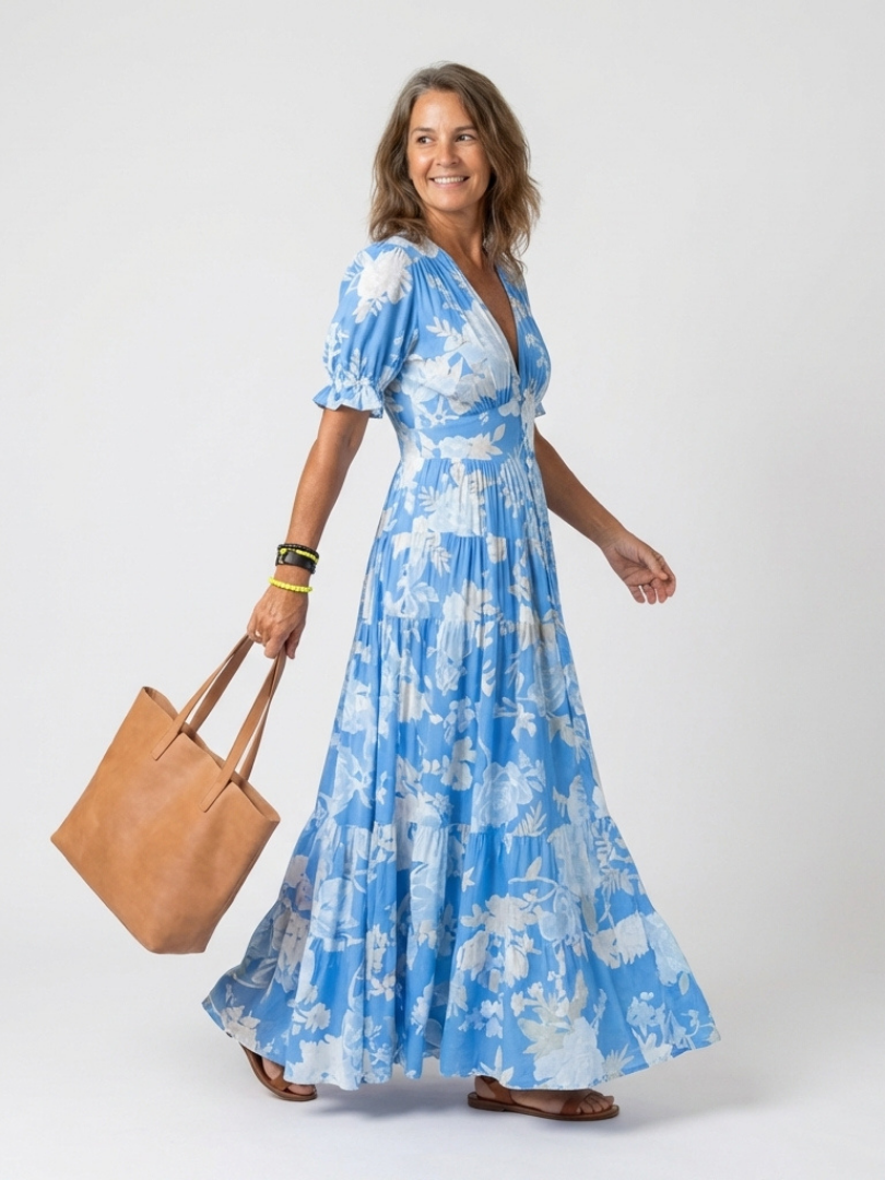 FJØRNA floral summer midi dress for women with short sleeves, featuring a vibrant floral pattern and lightweight fabric.