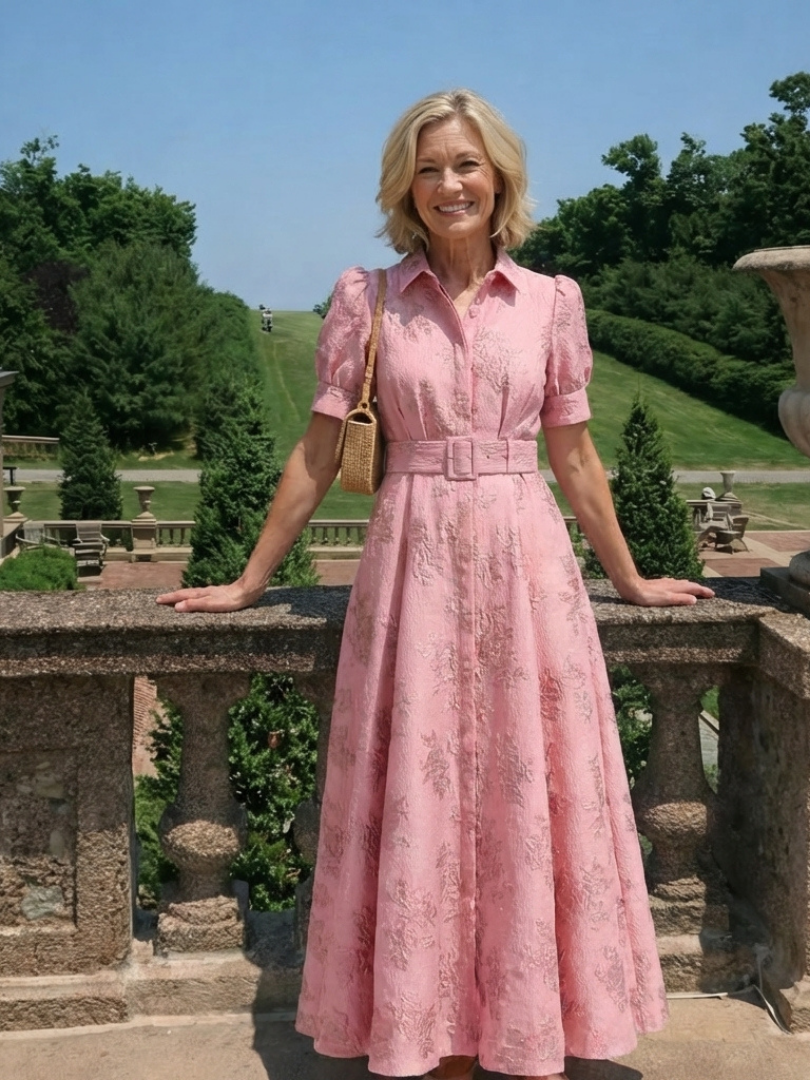 Floral short sleeve summer maxi dress for women by FJØRNA, featuring a flowing design and vibrant floral pattern.