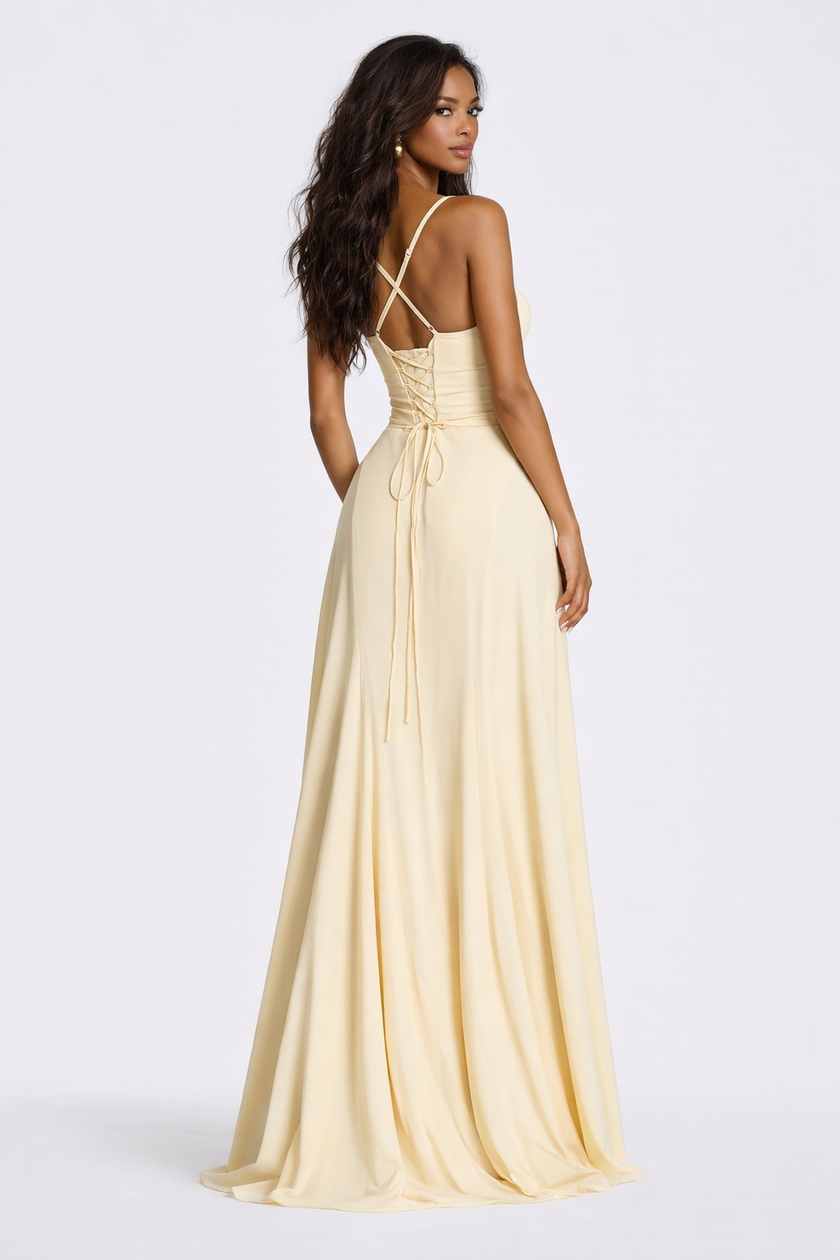 Elegant pale yellow FJØRNA maxi dress with corset-back design, soft drape fabric, and spaghetti straps for women.