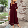 FJØRNA Elegant Maxi Dress in white, flowing fabric with a relaxed fit, perfect for casual or semi-formal occasions.