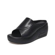 FJØRNA Eliza™ orthopedic slip-on wedge sandals in beige with cushioned footbed and ankle support, shown on a neutral background.