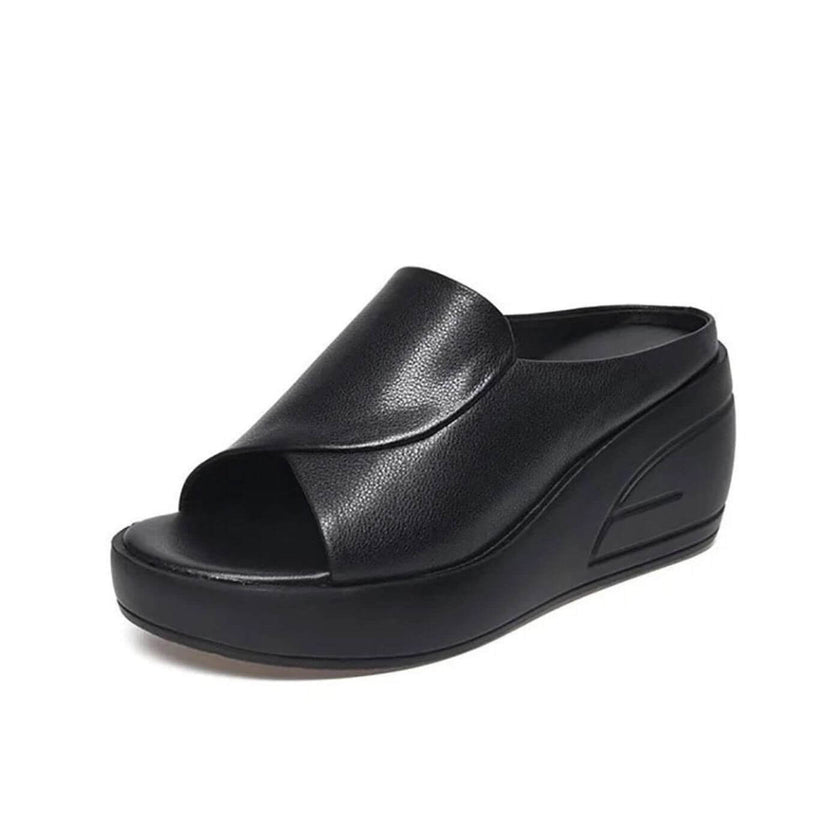 FJØRNA Eliza™ orthopedic slip-on wedge sandals in beige with cushioned footbed and ankle support, shown on a neutral background.