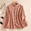 FJØRNA women's summer linen blouse with button front, casual style, light fabric, worn by a model in a relaxed outdoor setting.