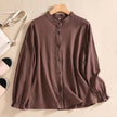 Linen summer blouse for women by FJØRNA featuring a button-front casual design, shown on a model in a relaxed fit.