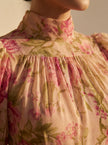 Close-up of a floral high-neck summer dress for women by FJØRNA, showing detailed fabric and floral pattern.