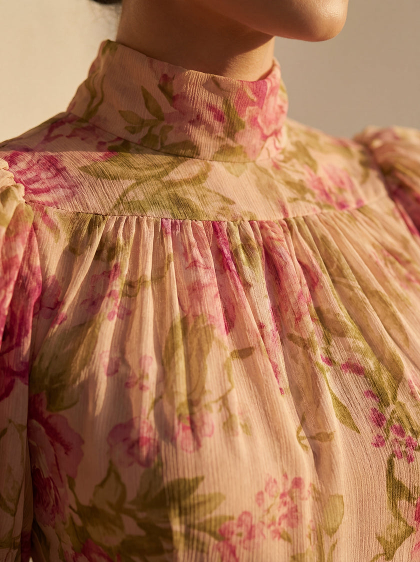 Close-up of a floral high-neck summer dress for women by FJØRNA, showing detailed fabric and floral pattern.