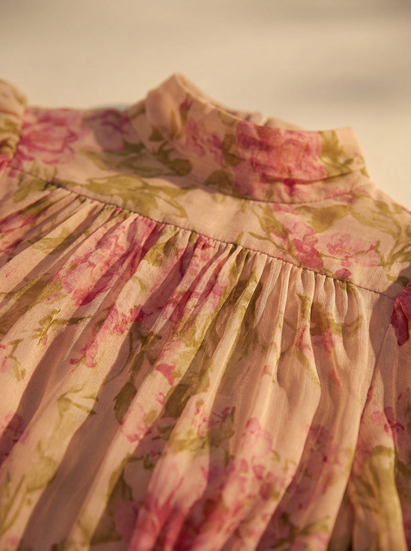 Close-up of FJØRNA floral high-neck summer dress for women, showing detailed fabric and vibrant floral pattern.