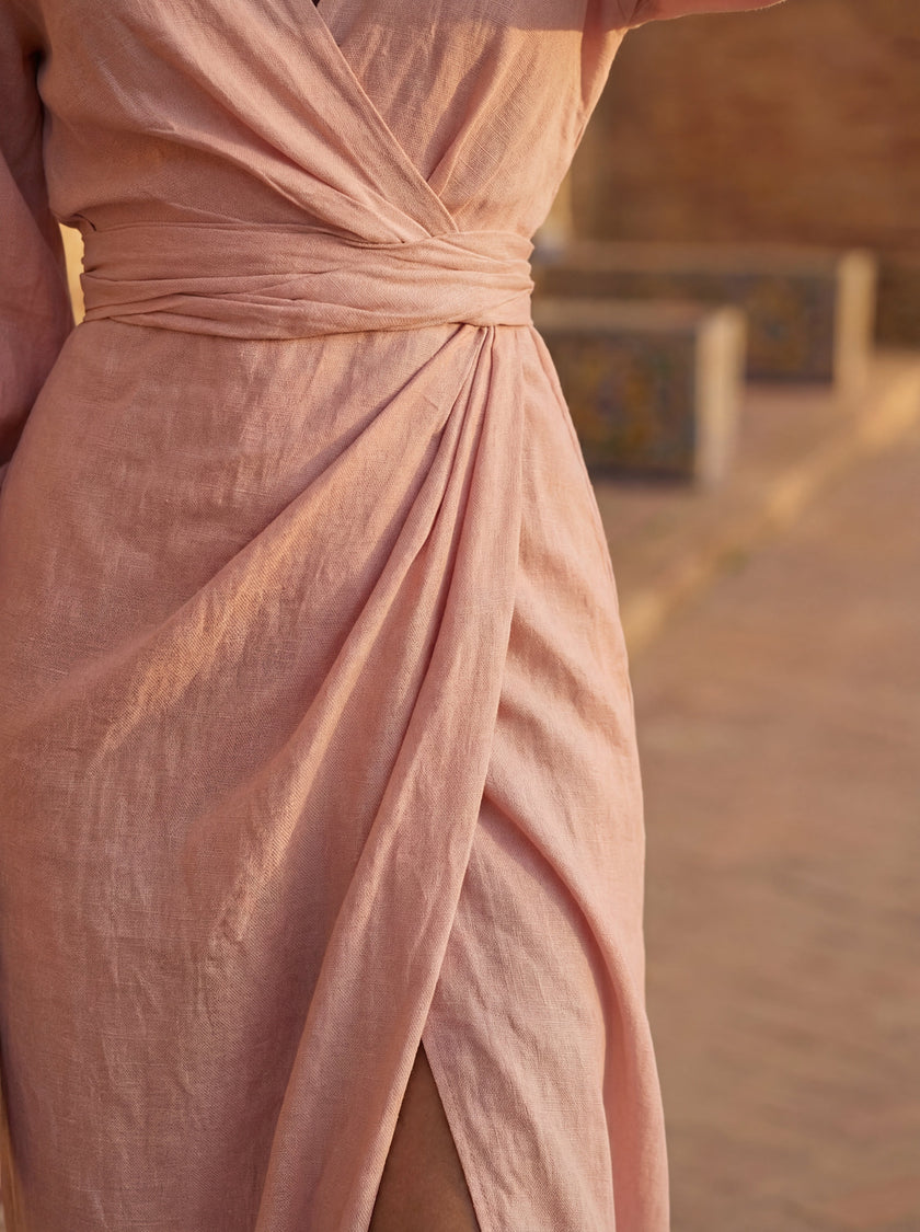 Close-up of FJØRNA women's elegant V-neck linen maxi dress showing textured fabric and detailed stitching.