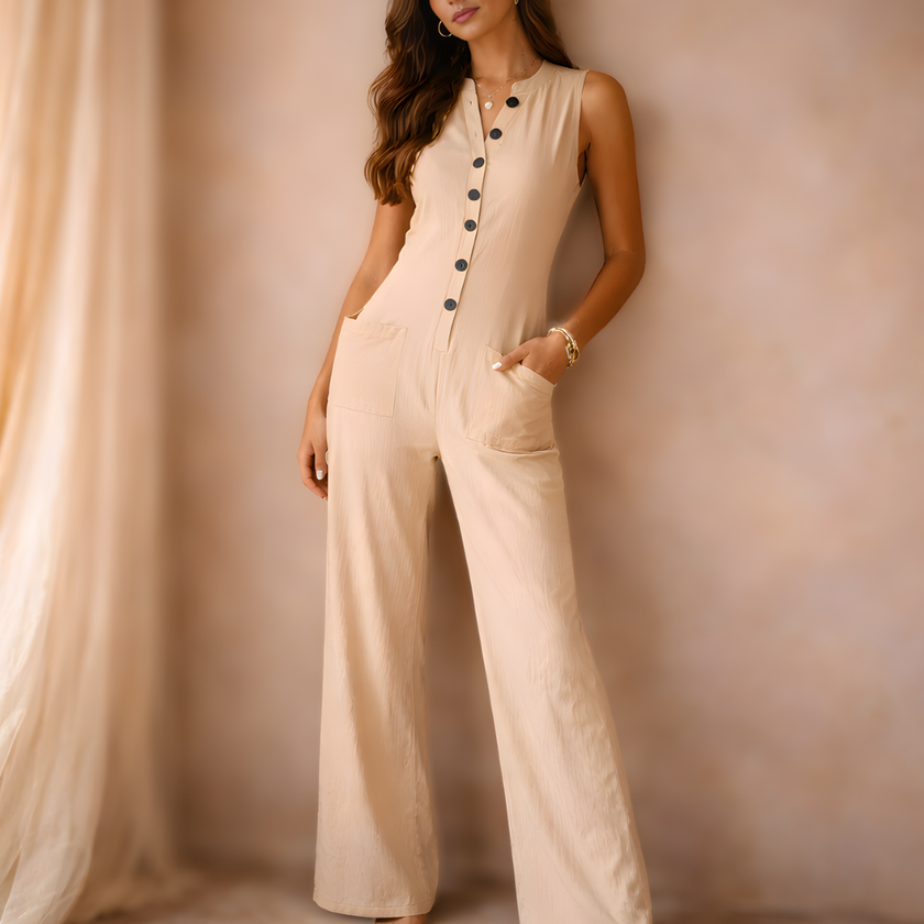 FJØRNA women's cotton linen wide-leg jumpsuit with button front and sleeveless design, shown flat on a white background.
