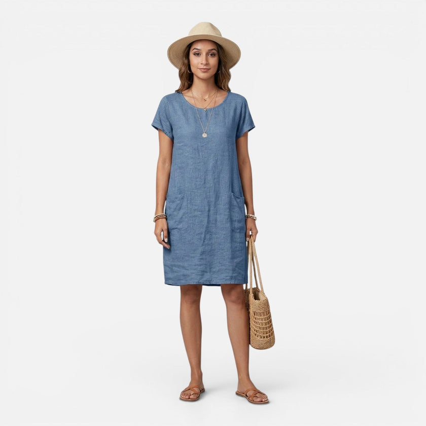 Women's lightweight FJØRNA dress with relaxed fit, breathable fabric, solid color, and practical pockets for casual wear.