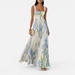 Women's floral elegant maxi dress by FJØRNA featuring a flowy design, vibrant flower print, and practical side pockets.