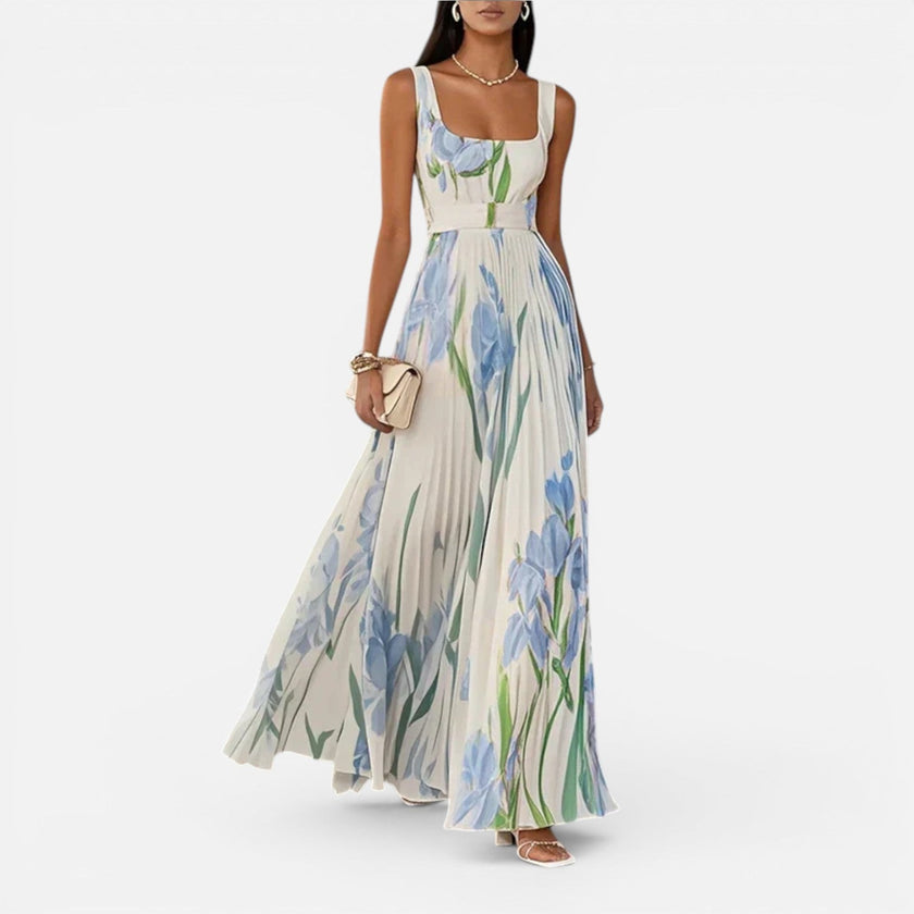 Women's floral elegant maxi dress by FJØRNA featuring a flowy design, vibrant flower print, and practical side pockets.
