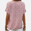 Women's floral cotton blouse by FJØRNA with button front, lightweight casual fit, featuring a colorful floral pattern.