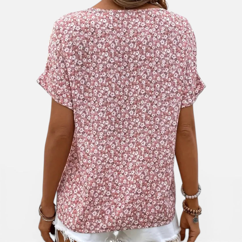 Women's floral cotton blouse by FJØRNA with button front, lightweight casual fit, featuring a colorful floral pattern.