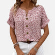 Women's floral blouse by FJØRNA, lightweight cotton shirt with button front and casual fit, featuring colorful flower patterns.