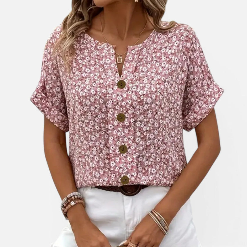 Women's floral blouse by FJØRNA, lightweight cotton shirt with button front and casual fit, featuring colorful flower patterns.