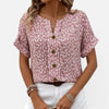 Women's floral blouse by FJØRNA, lightweight cotton shirt with button front and casual fit, featuring colorful flower patterns.