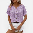 Lightweight women's floral cotton blouse by FJØRNA with button front and casual fit, featuring a vibrant floral pattern.