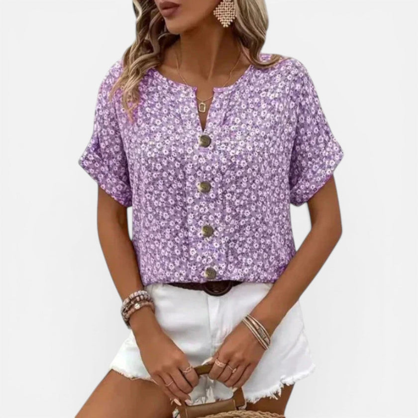 Lightweight women's floral cotton blouse by FJØRNA with button front and casual fit, featuring a vibrant floral pattern.