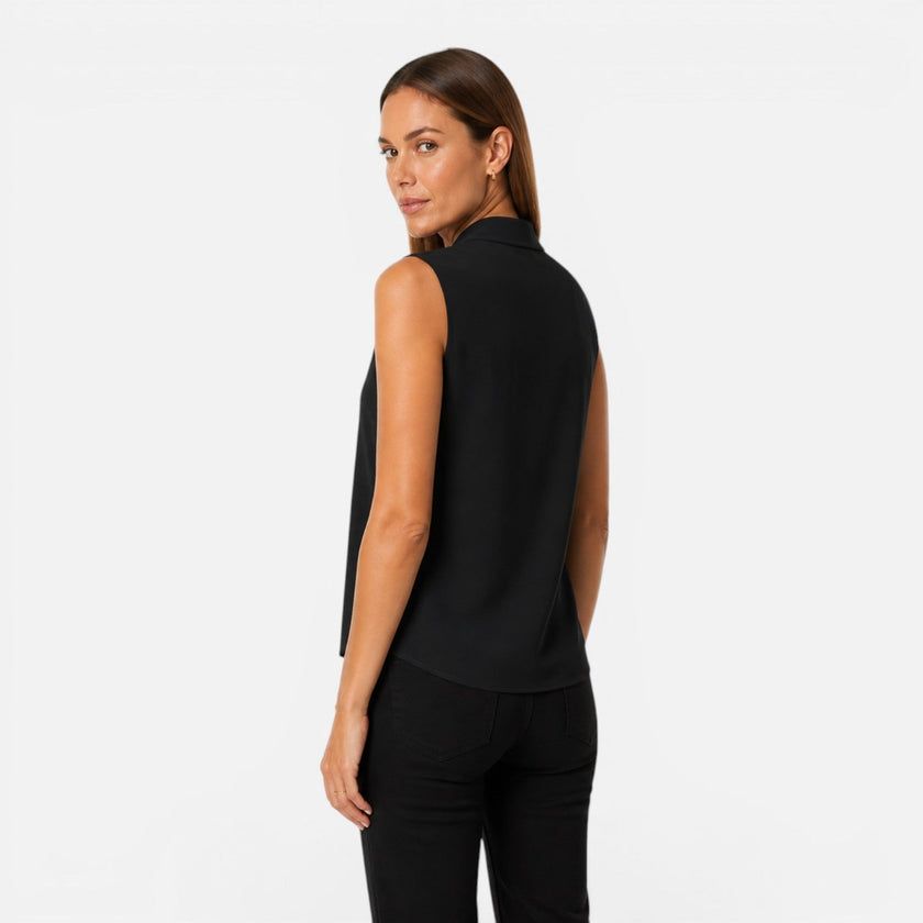 FJØRNA women's sleeveless blouse with elegant draped V-neck and timeless fit, shown in a stylish light-colored fabric.