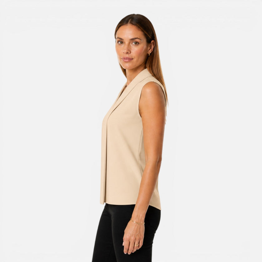 Women's sleeveless blouse by FJØRNA featuring an elegant draped V-neck and timeless fit, shown in a stylish, flowy fabric.
