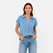 Women's lightweight V-neck short sleeve blouse by FJØRNA, relaxed fit, soft fabric, shown on a model with a casual, stylish look.