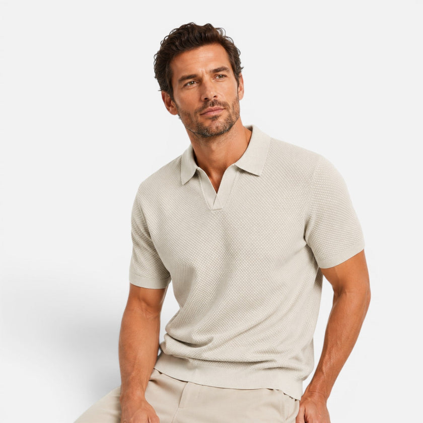 Men's FJØRNA slim fit knit polo shirt in lightweight, breathable fabric, shown in a close-up of the shirt's textured knit pattern.