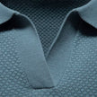 Men's slim fit knit polo shirt by FJØRNA, lightweight and breathable, shown in a close-up of the shirt's fabric and collar.