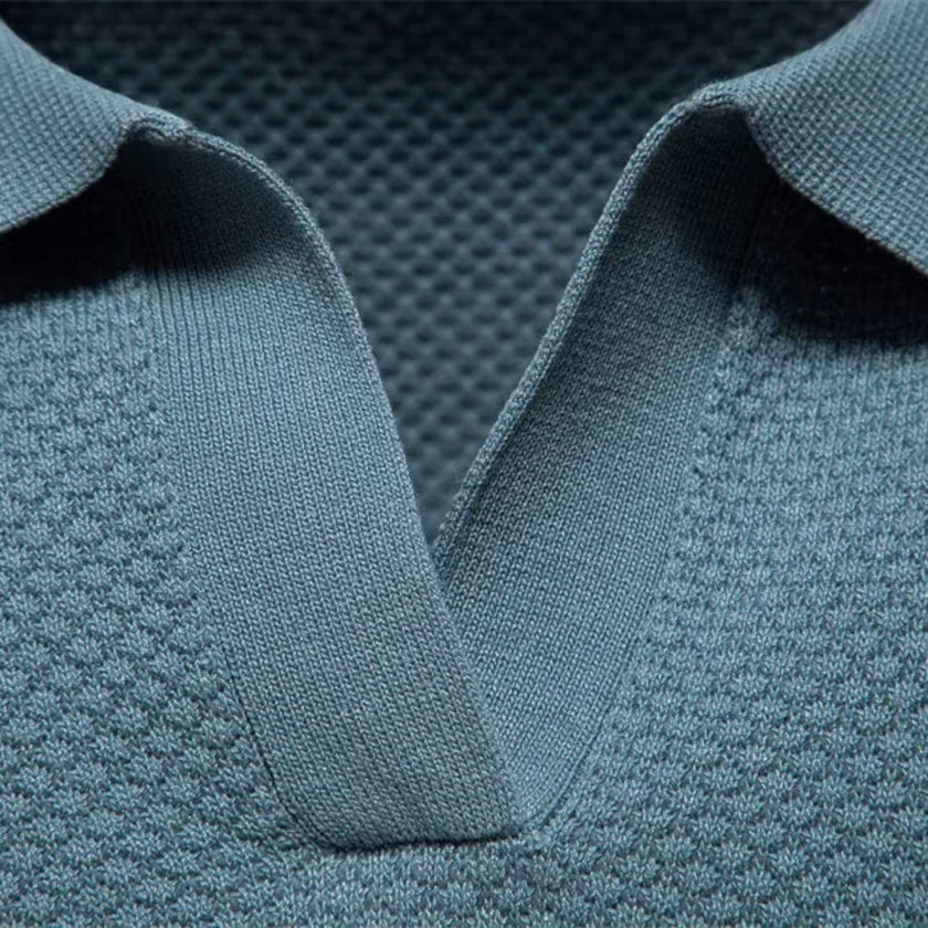 Men's slim fit knit polo shirt by FJØRNA, lightweight and breathable, shown in a close-up of the shirt's fabric and collar.