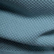 Men's slim fit knit polo shirt by FJØRNA, lightweight and breathable, shown in a natural pose highlighting the collar and fabric texture.