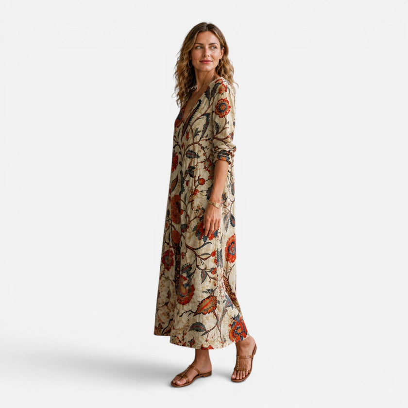 Women’s bohemian floral maxi dress by FJØRNA featuring a flowing silhouette and vibrant floral pattern.