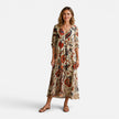 Women's bohemian floral maxi dress by FJØRNA with flowing fabric and vibrant floral pattern, perfect for casual or summer wear.