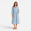 FJØRNA women's floral midi dress featuring a flowy silhouette and vibrant flower pattern, perfect for spring and summer occasions.