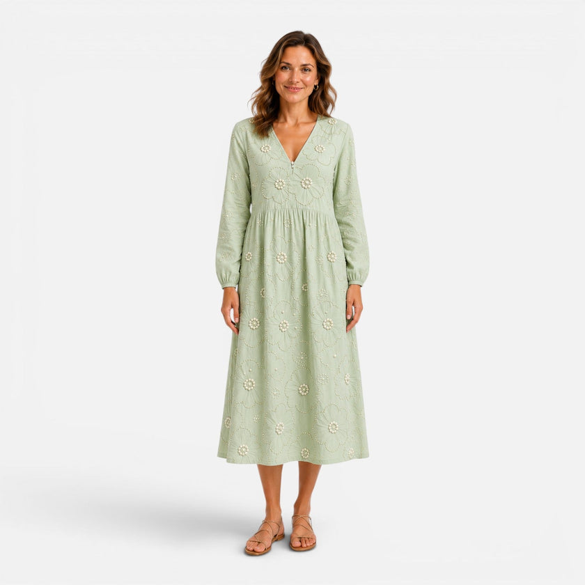 Women's floral midi dress by FJØRNA, featuring a flowy design and vibrant floral pattern, perfect for spring and summer occasions.