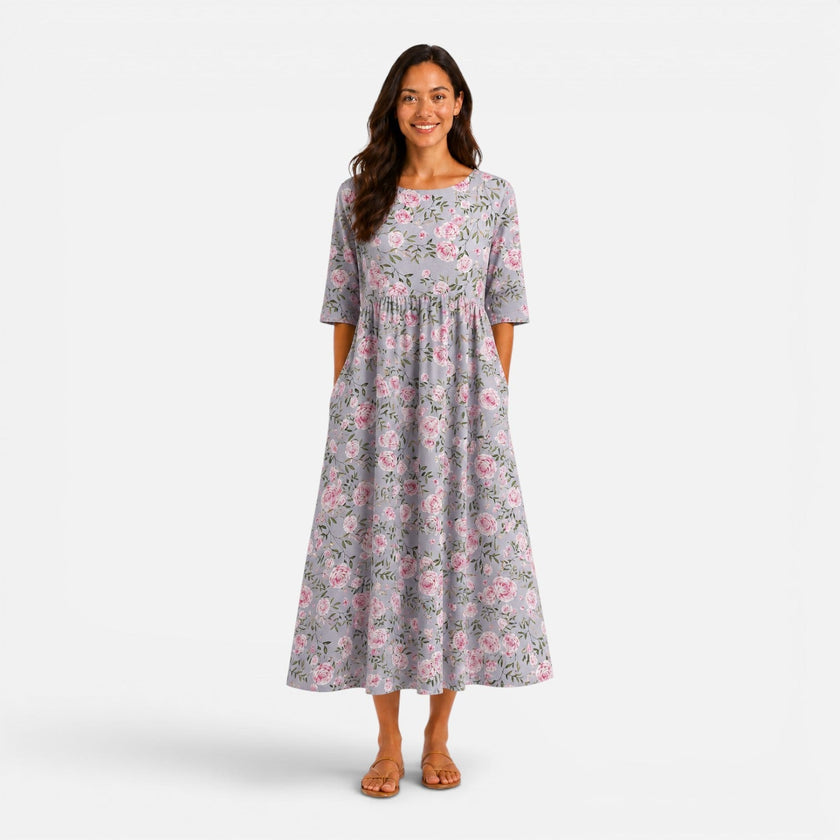 FJØRNA women's floral midi dress for spring and summer, featuring a lightweight, flowy fabric with vibrant floral pattern.