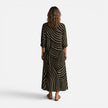 Women's flowy maxi dress by FJØRNA featuring an abstract print, lightweight fabric, and a relaxed, elegant fit.