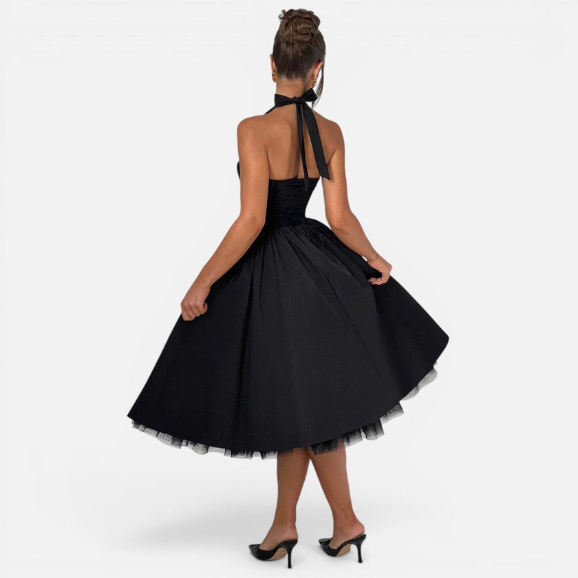Women's halter neck corset midi dress by FJØRNA, backless fit and flare party dress with elegant design and flowing silhouette.