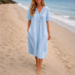 Women's linen beach dress by FJØRNA featuring a casual V-neck design, loose fit, midi length, perfect for summer beachwear.