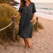 Women's linen beach dress by FJØRNA featuring a casual V-neck, loose fit, and midi length perfect for summer.